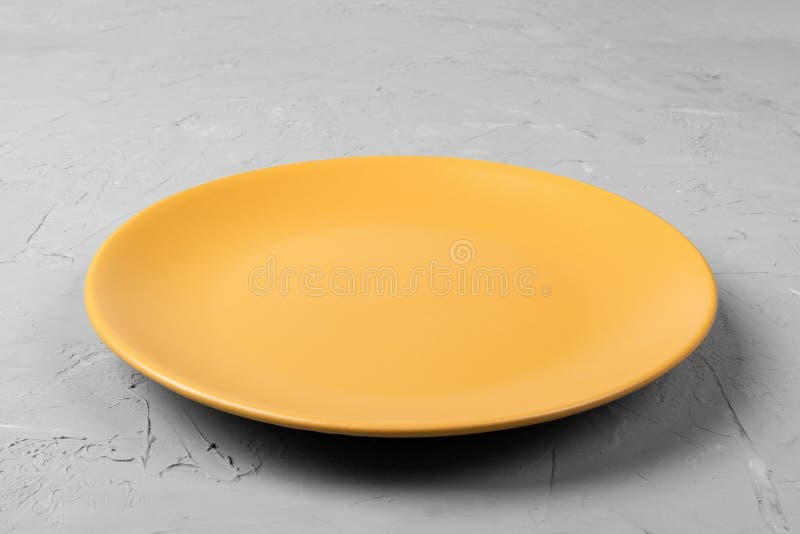 Vue supérieure de plat orange vide de rond mat sur l'espace foncé de copie de fond de ciment pour vous conception Vue de point de images libres de droits Vue supérieure de plat orange vide de rond mat sur l'espace foncé de copie de fond de ciment pour vous conception Vue de point de images libres de droits