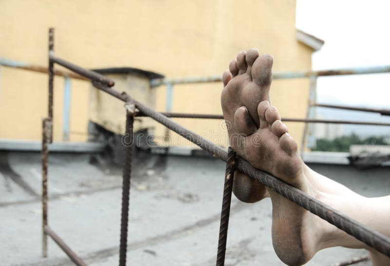 Creative photo of the dirty foots of homeless person. Creative photo of the dirty foots of homeless person