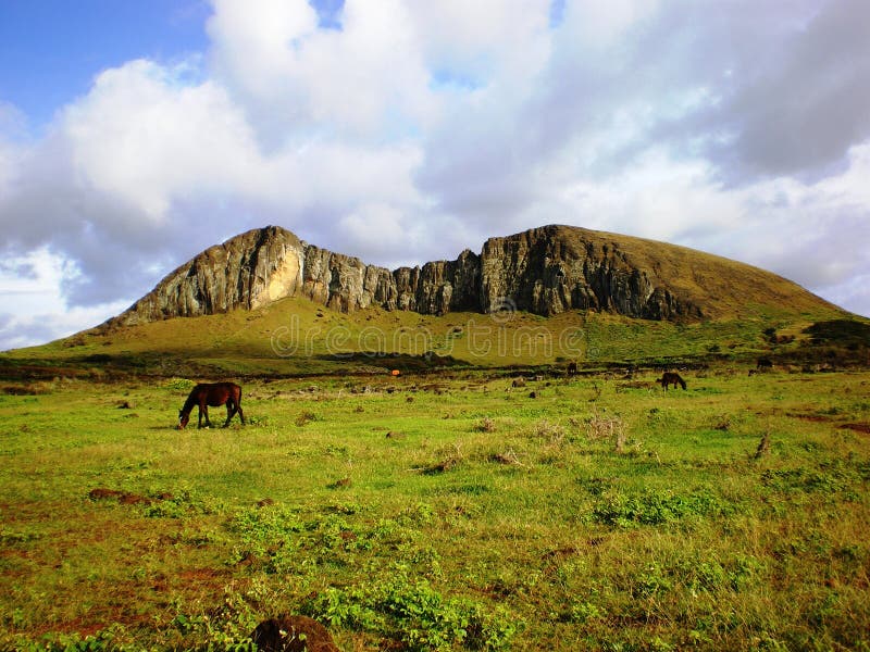 Photo of an extinct volcano on Easter Island (rapa nui) with horses grazing in the foreground. This was the place where the ancient Rapa nui civilization carved the Moai (see my other images) out of the volcanic stone. Photo of an extinct volcano on Easter Island (rapa nui) with horses grazing in the foreground. This was the place where the ancient Rapa nui civilization carved the Moai (see my other images) out of the volcanic stone.