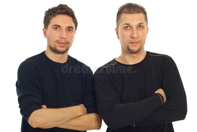 Two adults cousins standing with arms folded isolated on white background. Two adults cousins standing with arms folded isolated on white background