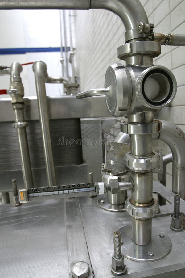 Pipes and control valves in dairy production factory. Pipes and control valves in dairy production factory