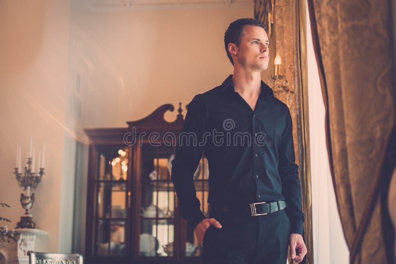 Välklädd man i lyxig husinre royaltyfria bilder