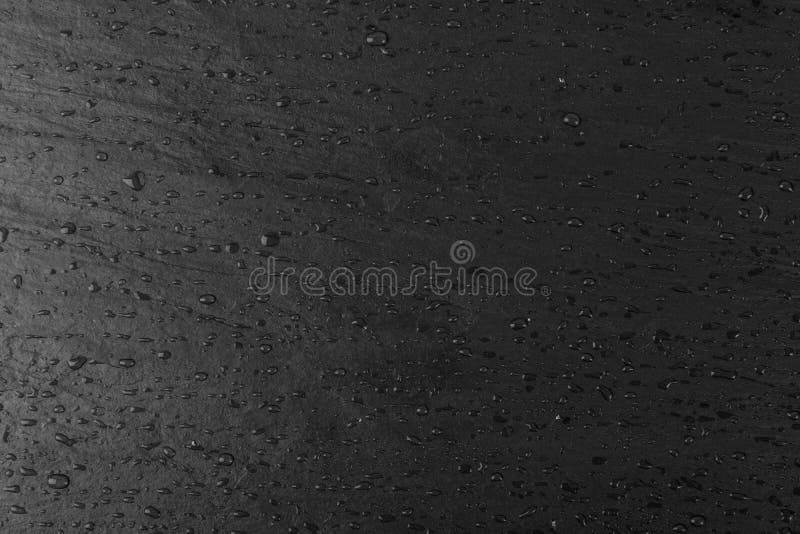 Wet black slate stone, food slate, slab surface, plate stone texture background. Chalkboard, graphite board, rock, slab rock pattern with water drops. Wet black slate stone, food slate, slab surface, plate stone texture background. Chalkboard, graphite board, rock, slab rock pattern with water drops