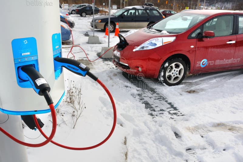 An electric car being charged at a parking lot in Toronto Canada. An electric car being charged at a parking lot in Toronto Canada