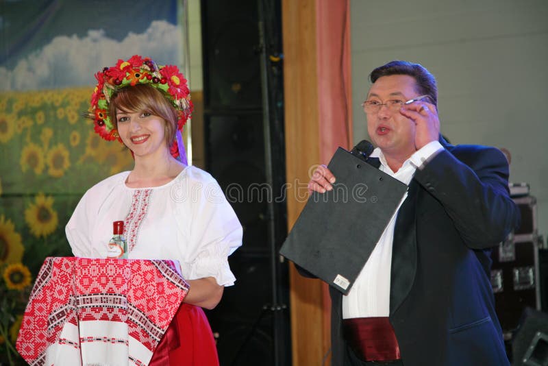 Performance in the restaurant of the country club Dacha 06.07.2012. St. Petersburg, Russia, Europe. At the presentation of the menu of Ukrainian national cuisine. Smiling young woman in the Ukrainian national clothes. Nikolay Y. Pozdeev - Entertainer, ready for anything. Nikolay Pozdeyev was an entertainer almost all high-profile concerts, performed several solo recitals at the St. Petersburg variety Theatre. Raikin, appeared frequently on television. From the beginning zero the genre of the film fit written in the red book of pop rarities. Today, the comedian Nikolai Pozdeev is the real entertainers in the world entertainers. Performance in the restaurant of the country club Dacha 06.07.2012. St. Petersburg, Russia, Europe. At the presentation of the menu of Ukrainian national cuisine. Smiling young woman in the Ukrainian national clothes. Nikolay Y. Pozdeev - Entertainer, ready for anything. Nikolay Pozdeyev was an entertainer almost all high-profile concerts, performed several solo recitals at the St. Petersburg variety Theatre. Raikin, appeared frequently on television. From the beginning zero the genre of the film fit written in the red book of pop rarities. Today, the comedian Nikolai Pozdeev is the real entertainers in the world entertainers.
