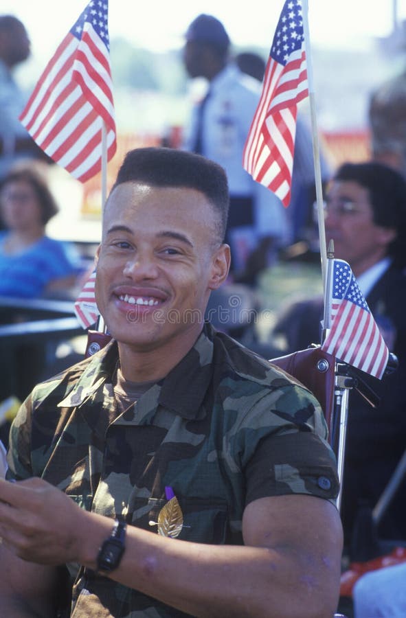 African-American Soldier in Wheelchair with American Flags, Washington, D.C. African-American Soldier in Wheelchair with American Flags, Washington, D.C.