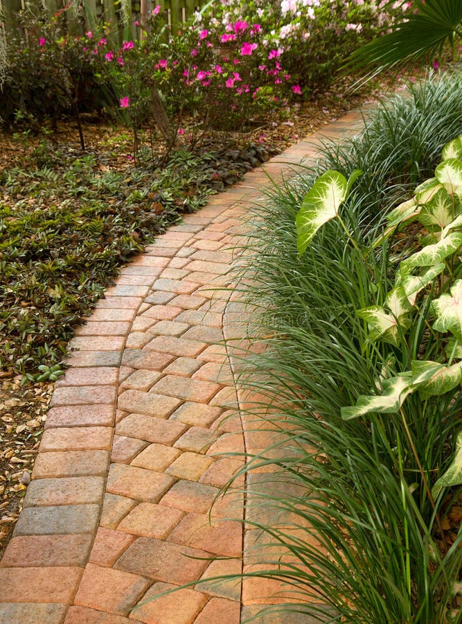 Curved garden path winds around a beautiful garden. Curved garden path winds around a beautiful garden