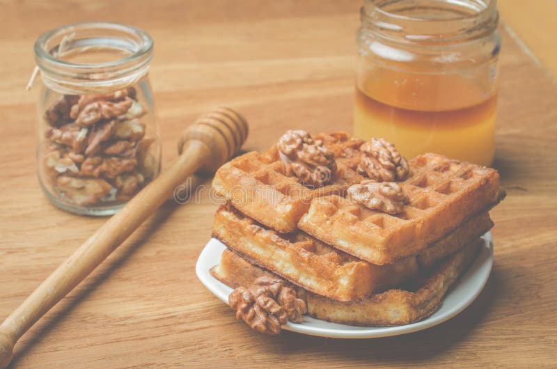 Wafers. Home made pastries, wafers and walnut with honey on a wooden background royalty free stock images Wafers. Home made pastries, wafers and walnut with honey on a wooden background royalty free stock images