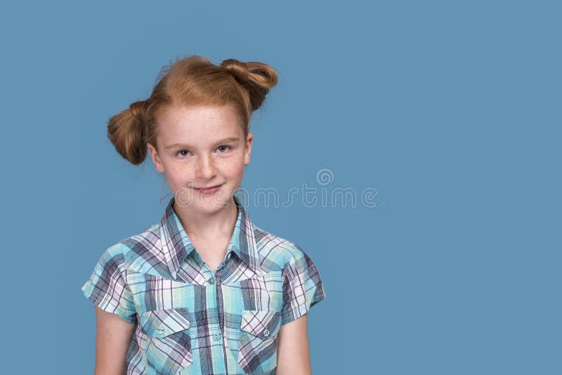 Shot Of A Little Funny Naughty Redhead Girl Against Blue Background