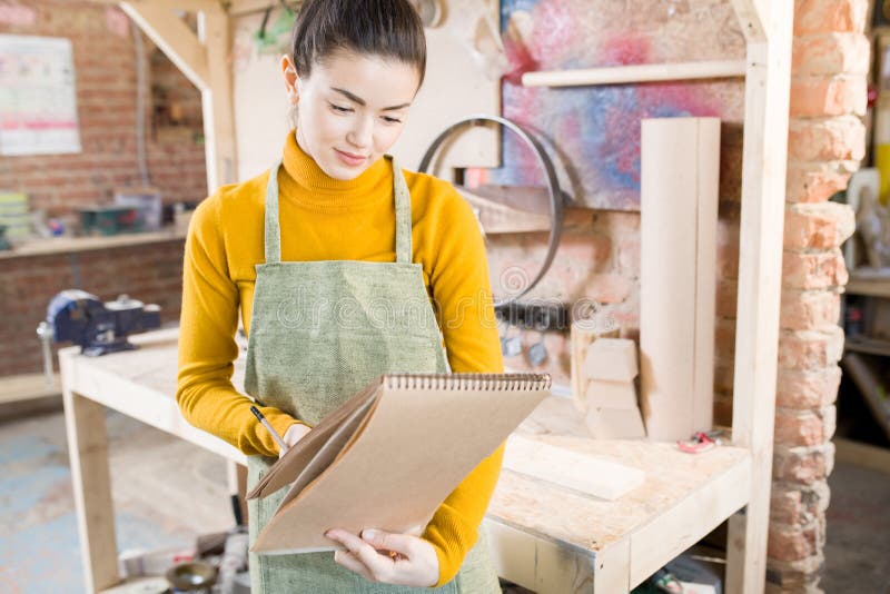 Smiling Female Artisan in Workshop stock photo Smiling Female Artisan in Workshop stock photo