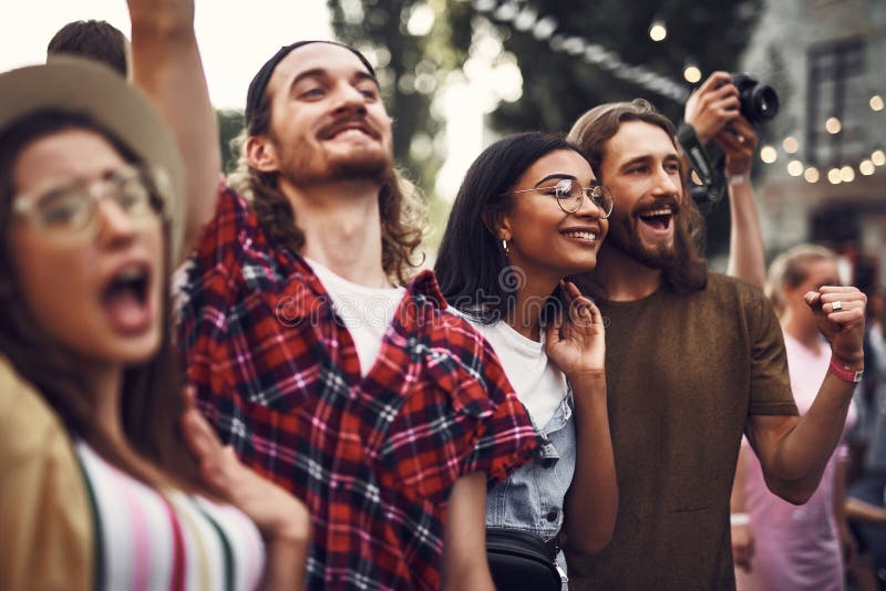 Group of cheerful hipsters spending time outdoors royalty free stock photography Group of cheerful hipsters spending time outdoors royalty free stock photography
