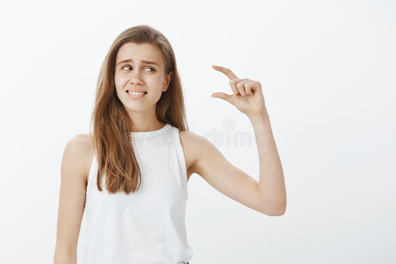 waist-up-shot-disappointed-awkward-attractive-woman-white-tank-top-raising-hand-shaping-small-item-looking-waist-up-shot-116009709.jpg