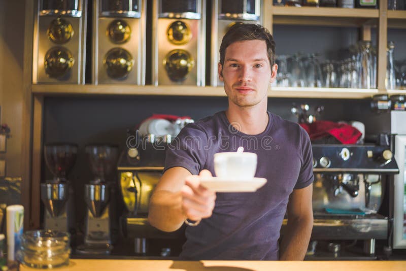 Waiter holding coffee cup stock image. Image of barista 45127041