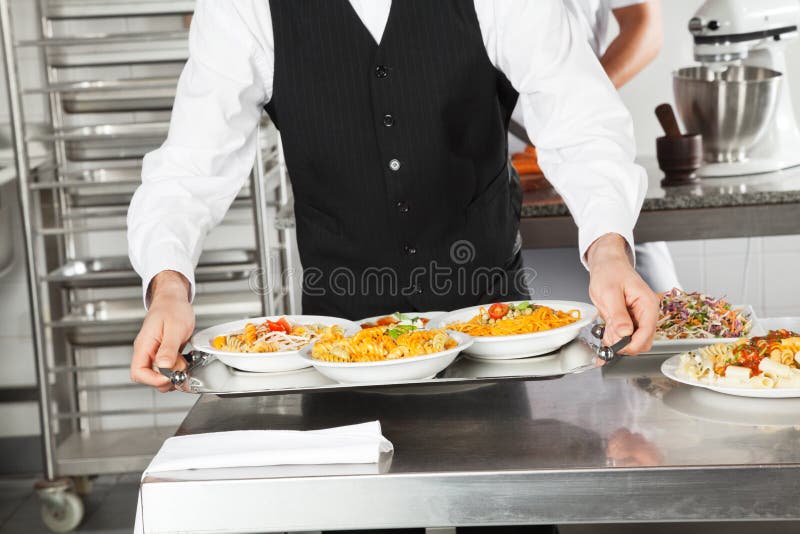 Waiter Holding Pasta Dishes In Tray royalty free stock photo Waiter Holding Pasta Dishes In Tray royalty free stock photo