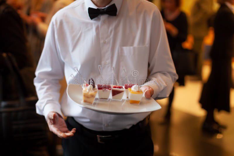 Waiter Serving Food during Reception Stock Image - Image of people