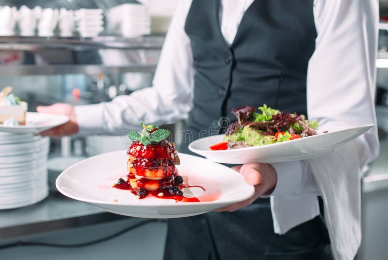 Waiter Serving in Motion on Duty in Restaurant. the Waiter Carries Dishes. Stock Image Image