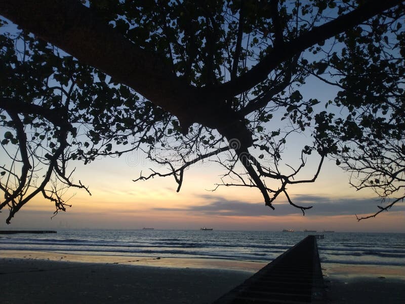 Waiting for the sun to rise on the beautiful beach stock image