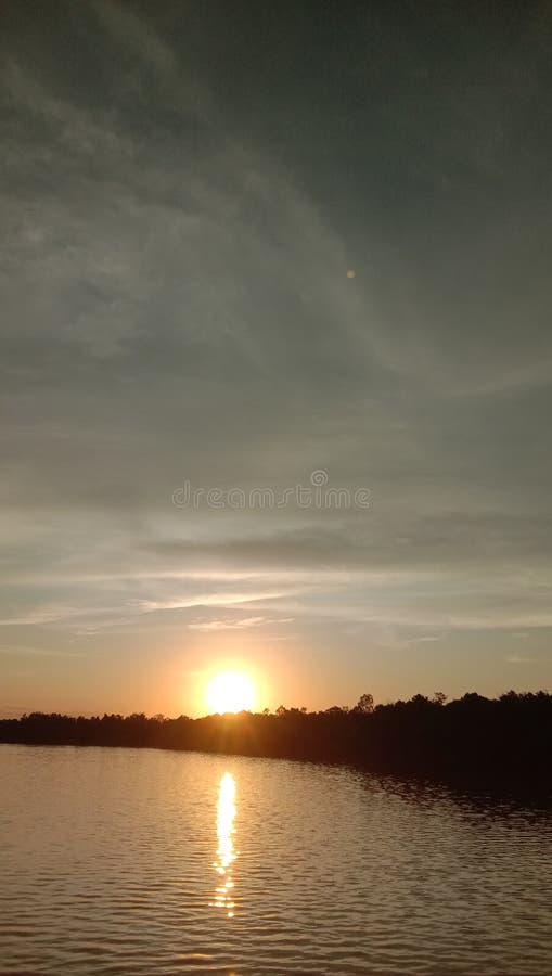 Waiting for the sun to rise on the shore of the Kahayan river stock image