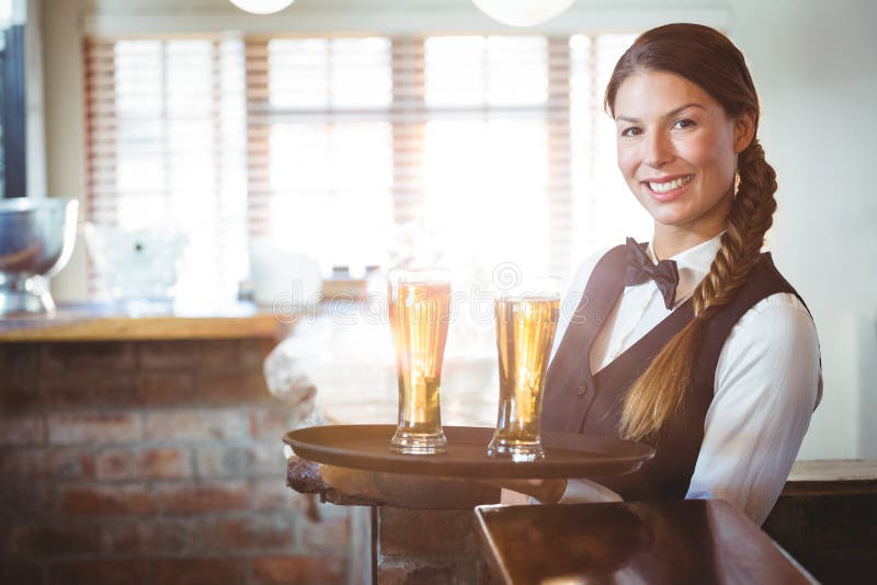Waitress holding beers stock photo. Image of server, expertise 73243536