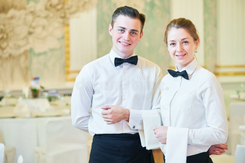 Waitress woman and waiter man in restaurant