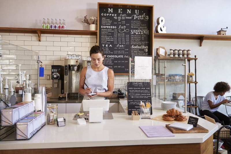 Waitress Writing Down an Order at the Counter of Coffee Shop Stock