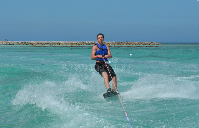 Wakeboarder Carving on His Backside To Turn in Aruba Stock Image
