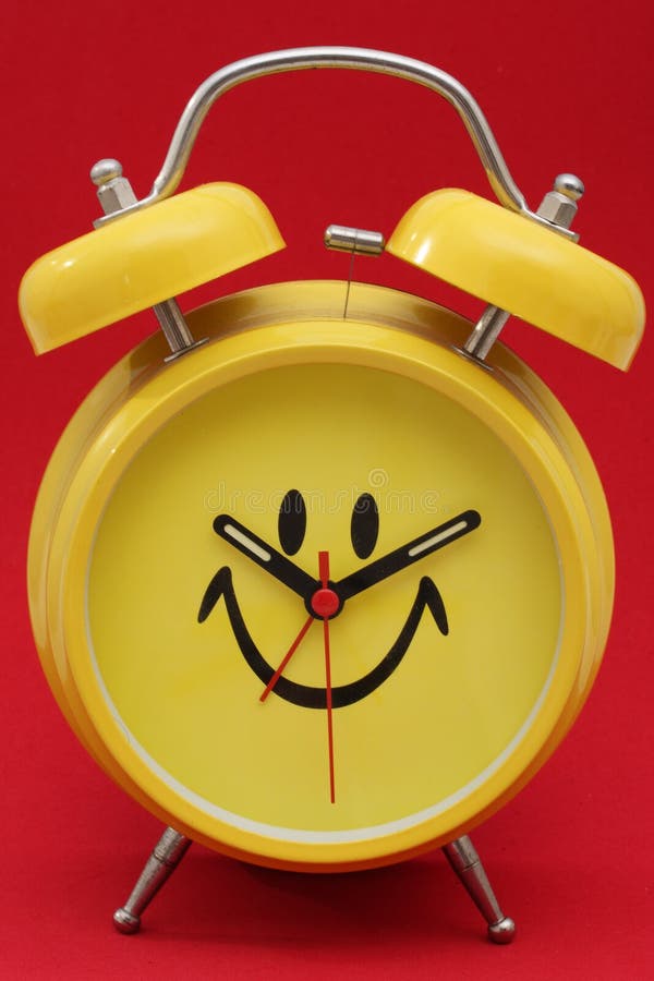 Happy face alarm clock on red background. Happy face alarm clock on red background