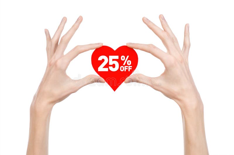 Valentine's Day discounts topic: Hand holding a card in the form of a red heart with a discount of 25% on an isolated white background. Valentine's Day discounts topic: Hand holding a card in the form of a red heart with a discount of 25% on an isolated white background