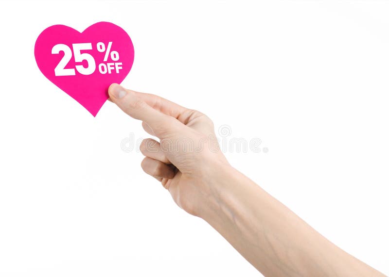 Valentine's Day discounts topic: Hand holding a card in the form of a pink heart with a discount of 25% on an isolated white background. Valentine's Day discounts topic: Hand holding a card in the form of a pink heart with a discount of 25% on an isolated white background