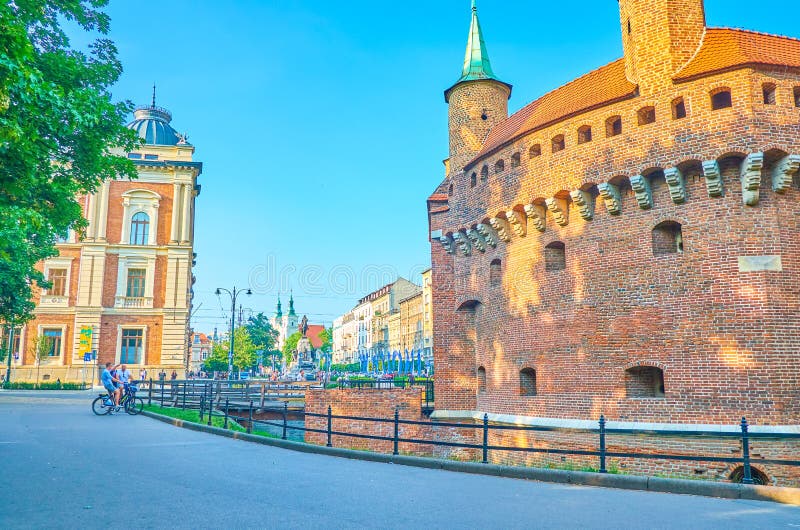 KRAKOW, POLAND - JUNE 11, 2018: The medieval defensive Barbakan structure nowadays located in the middle of the city, on June 11 in Krakow. KRAKOW, POLAND - JUNE 11, 2018: The medieval defensive Barbakan structure nowadays located in the middle of the city, on June 11 in Krakow