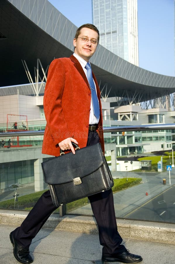 Walking businessman with suitcase