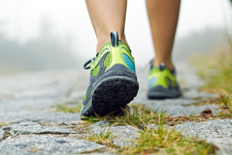 Woman walking in mountains in sport shoes. Woman walking in mountains in sport shoes