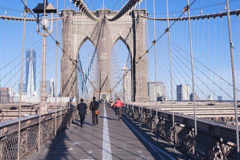 NEW YORK CITY - OCTOBER 26: The pedestrian walkway along The Brooklyn Bridge in New York City on October 26, 2013. Approximately 4,000 pedestrians and 3,100 cyclists cross this historic bridge each day. NEW YORK CITY - OCTOBER 26: The pedestrian walkway along The Brooklyn Bridge in New York City on October 26, 2013. Approximately 4,000 pedestrians and 3,100 cyclists cross this historic bridge each day.