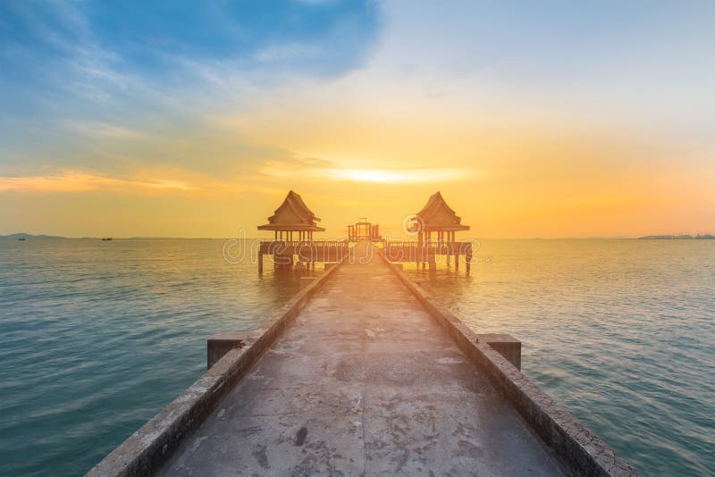 Walking way leading to sunset ocean skyline