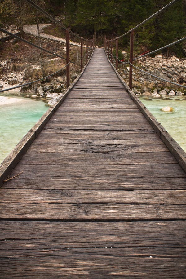 Walking on wooden footbridge crossing over turquoise river of soca, triglav national park, slovenia royalty free stock photography Walking on wooden footbridge crossing over turquoise river of soca, triglav national park, slovenia royalty free stock photography