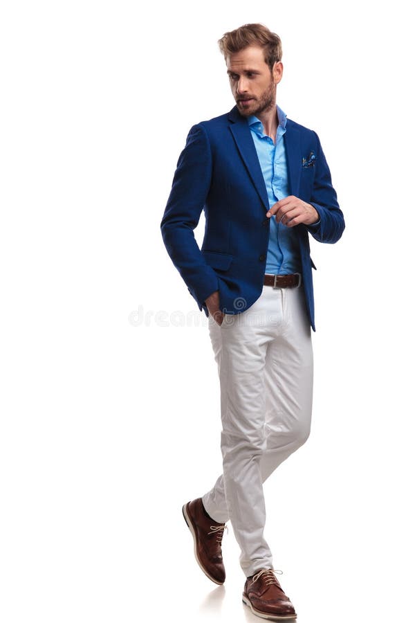 Walking young smart casual man looks back over his shoulder