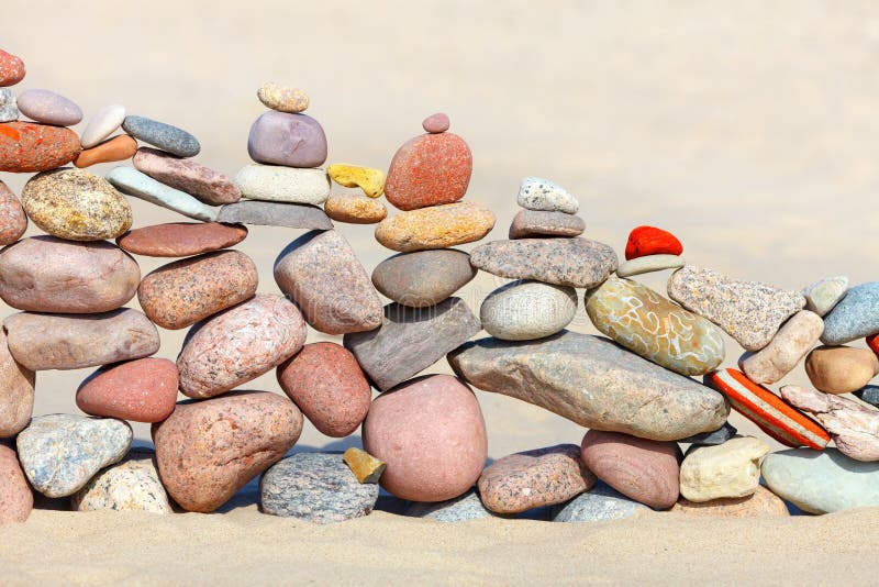 Stack of colored balanced rocks on the beach