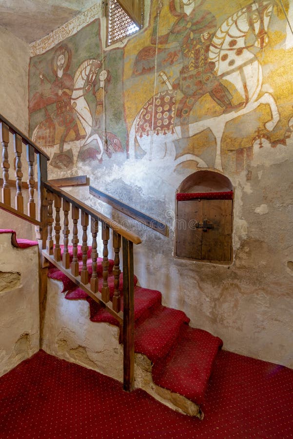 Wall with Coptic fresco paintings and staircase leading to the Church of St. Paul & St. Mercurius, Egypt