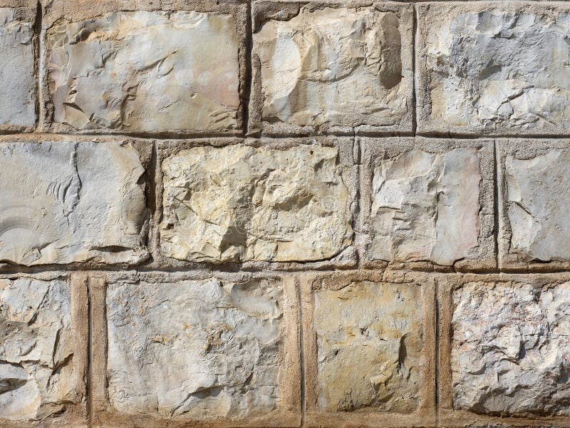 The wall of large stones of yellow tones, reinforced with cement in natural light. stock photography The wall of large stones of yellow tones, reinforced with cement in natural light. stock photography