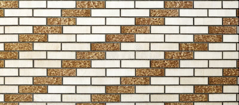 The wall is lined with white and brown decorative bricks. The bricks create a rhythmic diagonal pattern.