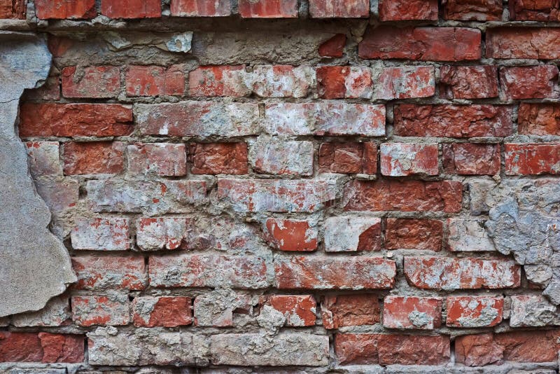 The wall of the old brick house .