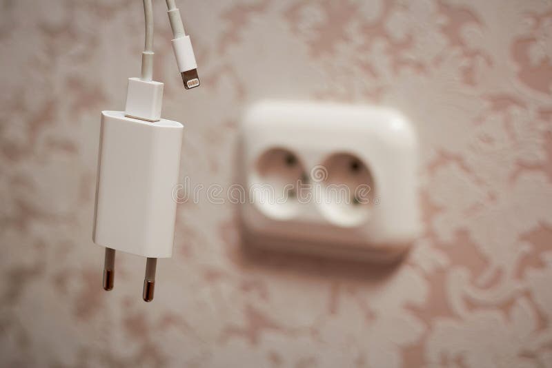 On the Wall There is an Electrical Outlet and a Phone Charger Stock Image Image of network