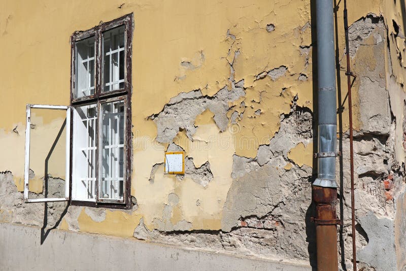 Wall and window of an old ruined building stock image