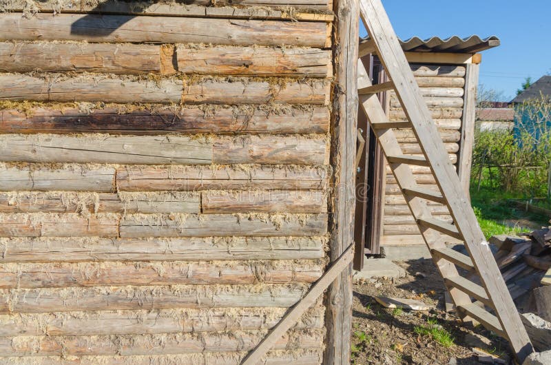 The old walls of the barn in the gap scored moss, insulation stock photo