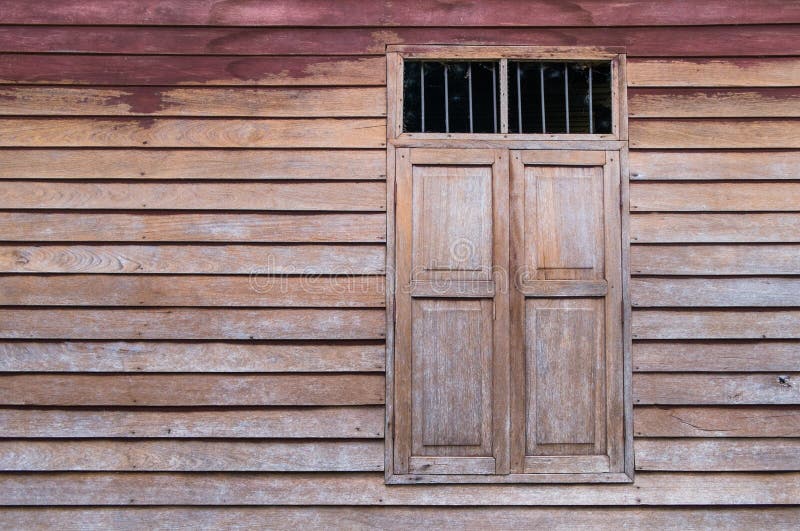 Walls and windows, stained wood and old brown stains in rural areas in thailand. Walls and windows, stained wood and old brown stains in rural areas in thailand.