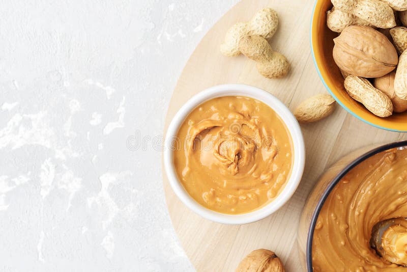 Walnut Butter Made of Peanuts, Almonds and Walnut on a Grey Background