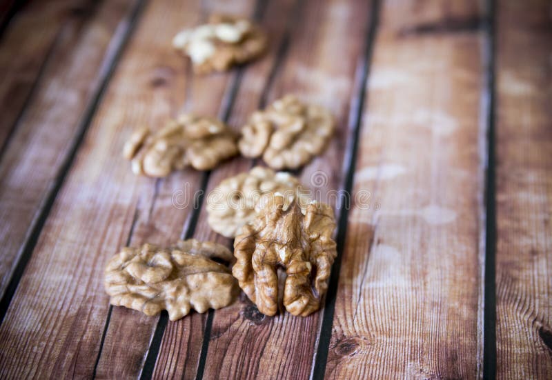 Walnut kernels on rustic old wooden table, shallow depth of field