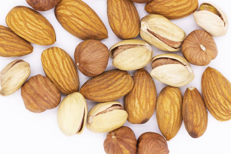 Walnut platter. A bunch of different nuts on a white background-pistachios, almonds and hazelnuts