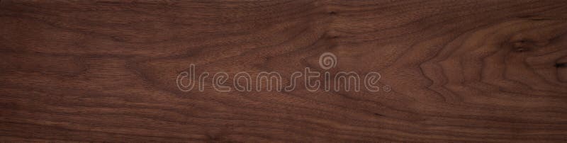 Walnut wood texture. Natural texture background of North American walnut wood board. Long wood plank texture. royalty free stock photo.