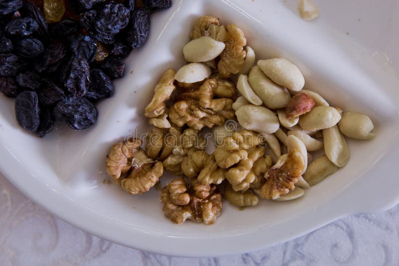 Walnuts, black cheese, white raisins, nuts royalty free stock photography